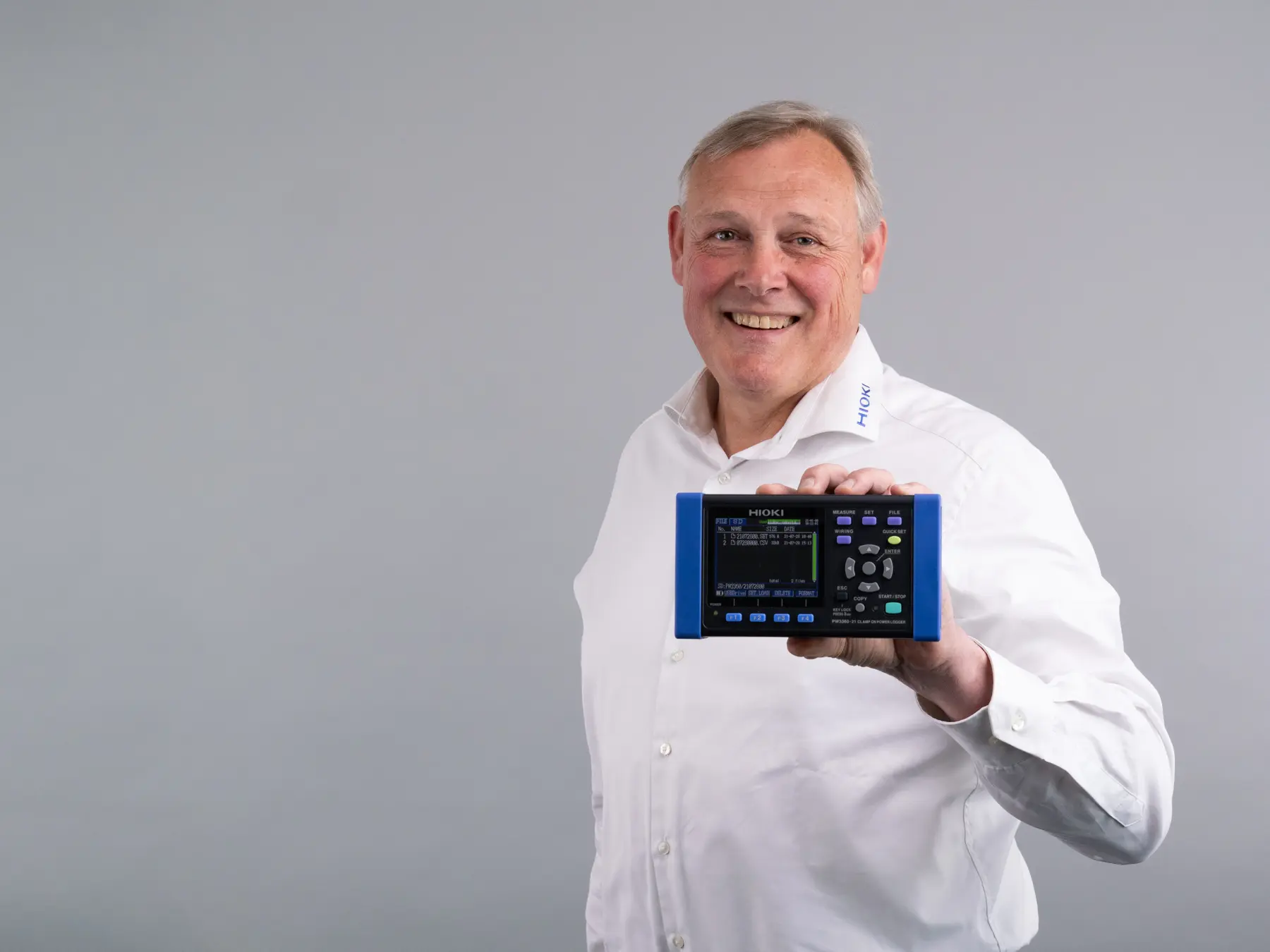 HIOKI PW3360-20 clamp on power logger white male holding